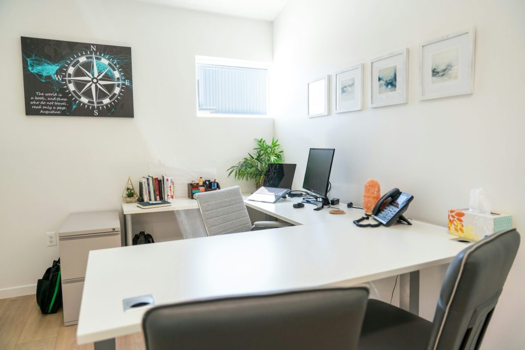 Modern office space with a desk, computer and decor.